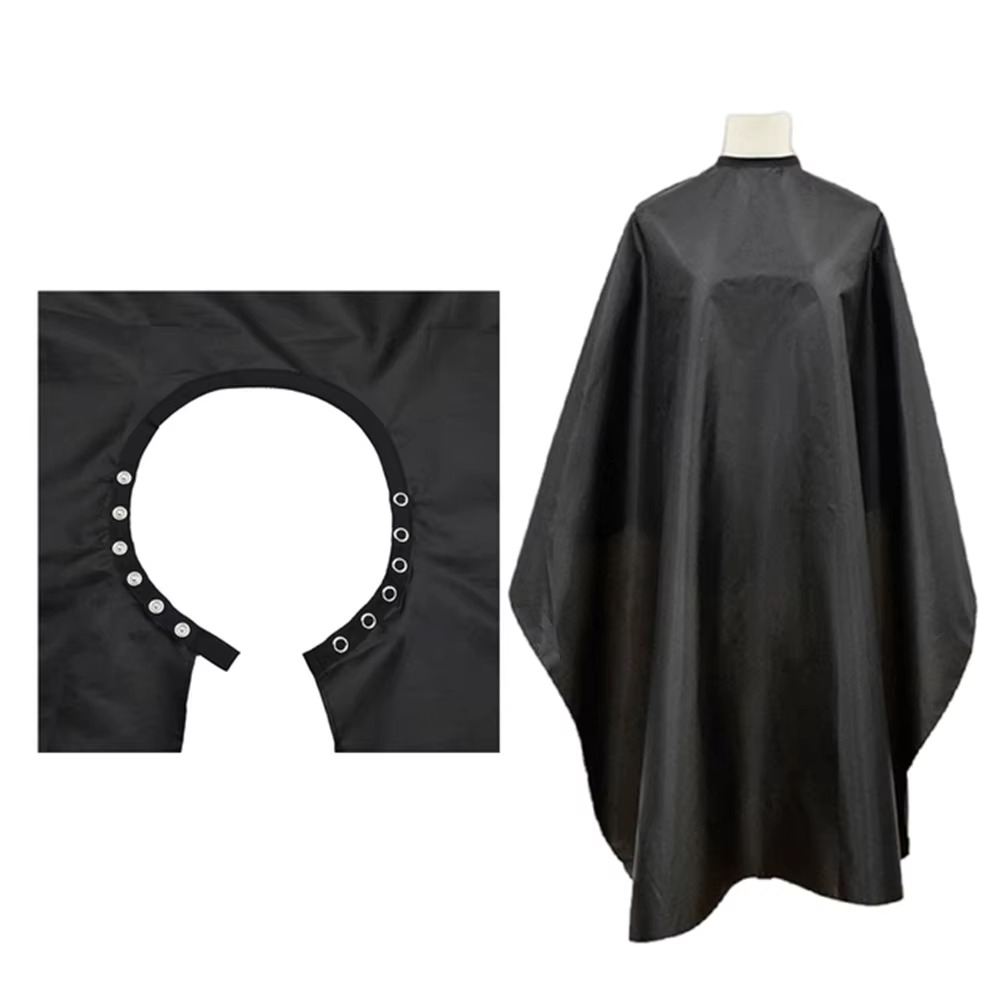 Cape de coiffure noire antistatique à col boutonné pour salon, tablier de coiffeur, fournitures de b